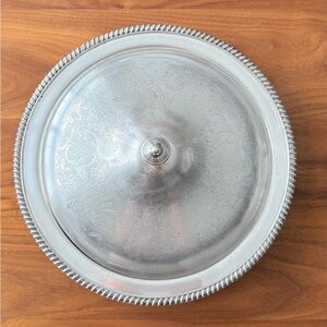 This is a vintage silver-plated serving tray with a lid.